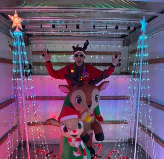 Brian and Multiple Rudolph inflatables in a U-Haul decorated for the holidays.